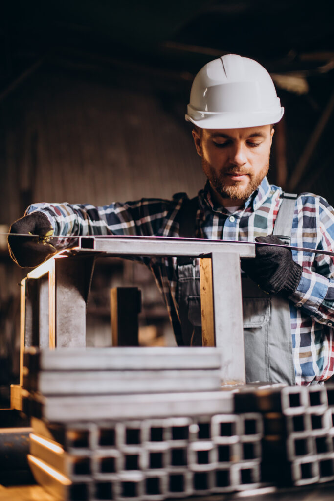 workman wearing har hat with measuring ruler factory